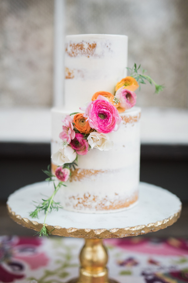 half naked wedding cake with floral cascade
