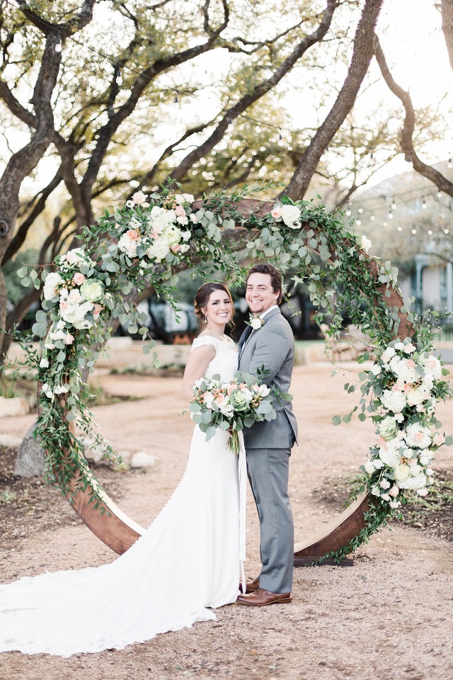 flower covered circle wedding arch backdrop