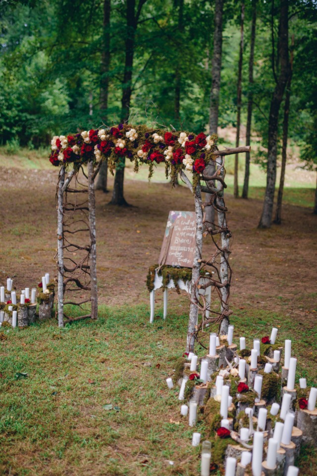 romantic floral wedding ceremony decor with hundreds of candles