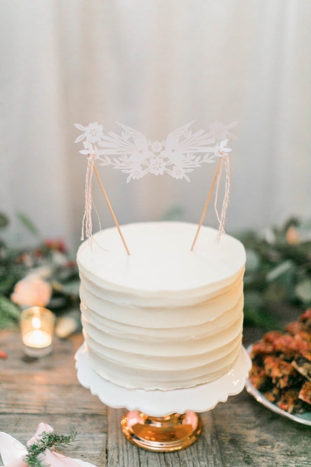 Simple white wedding cake with banner