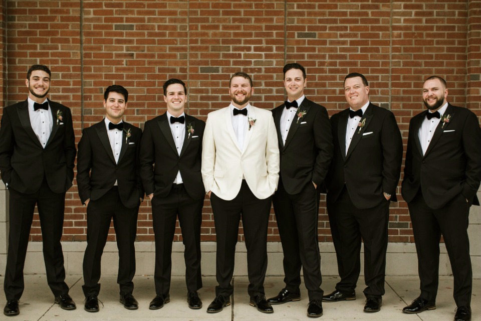 black and white groom and his men