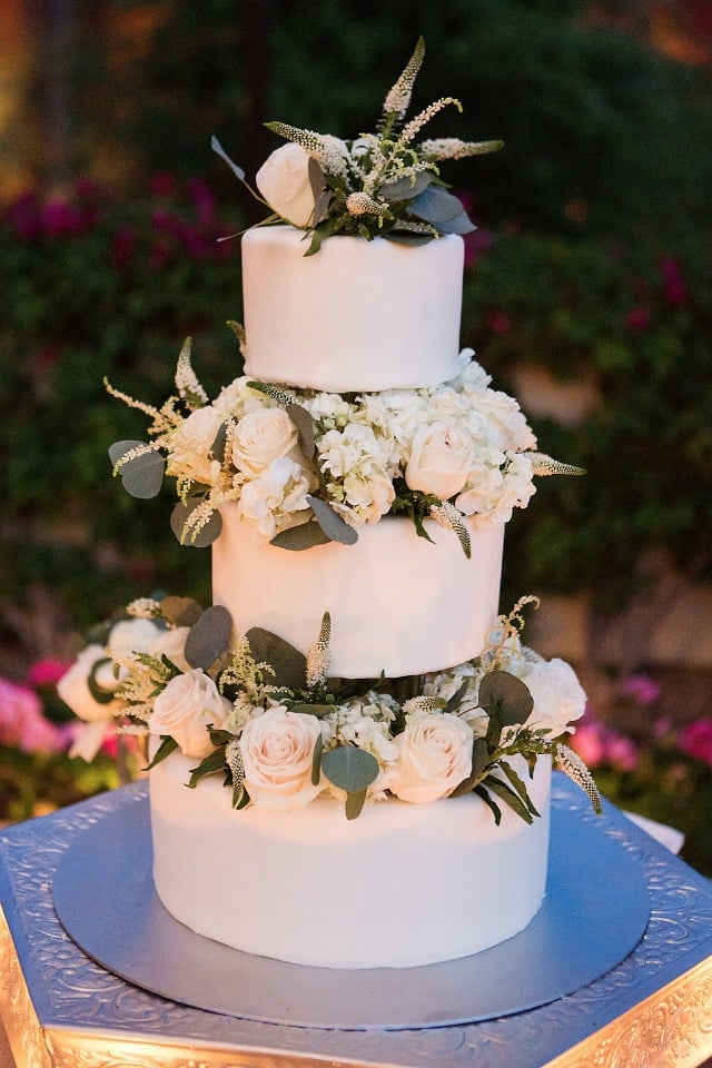 wedding cake with a side of flowers