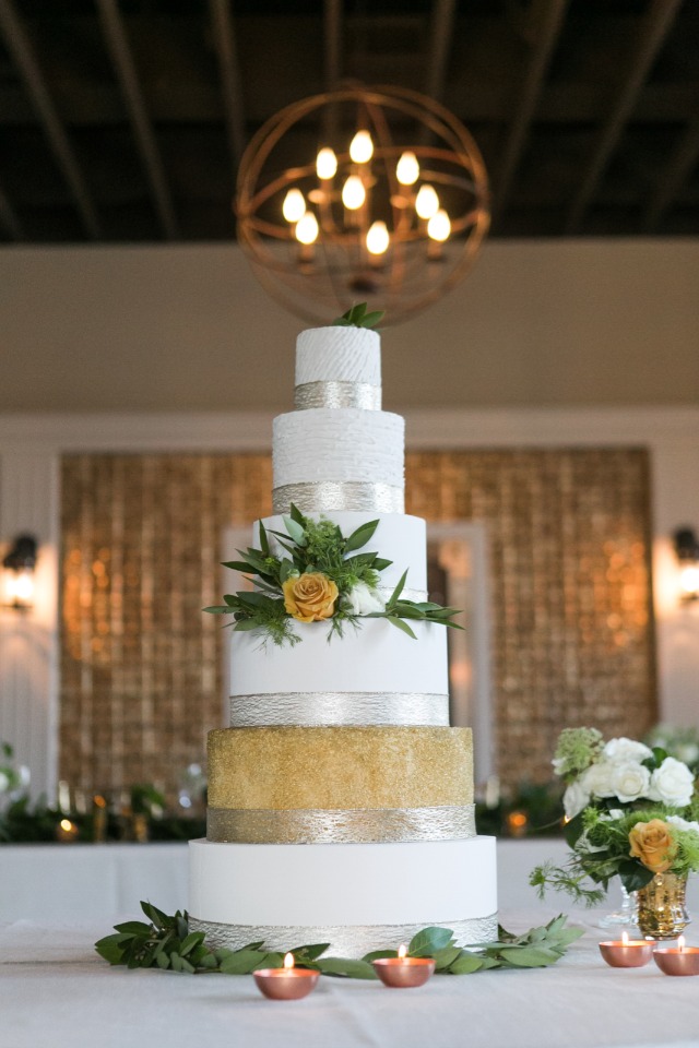 Gold silver and white cake with greenery