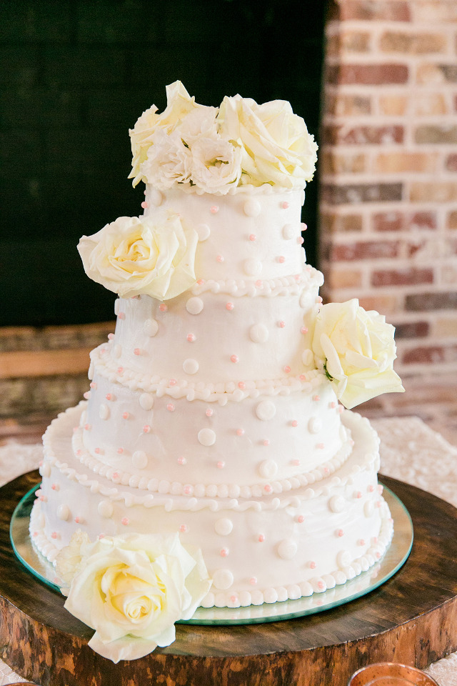 white wedding cake with pink polks dots