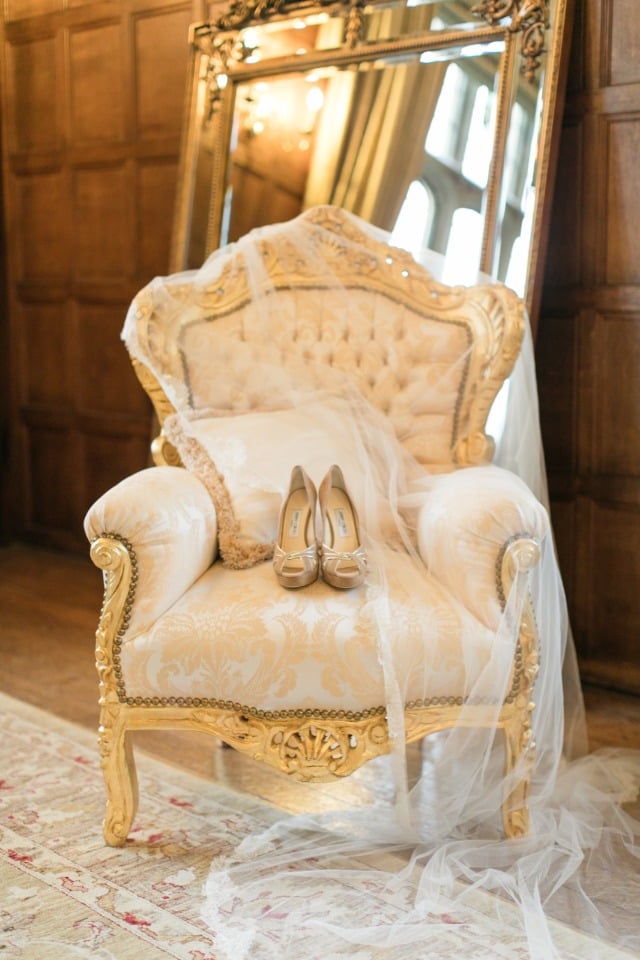 gold and ivory arm chair with veil and wedding shoes