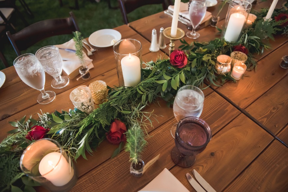 Garland centerpiece with red roses and candles