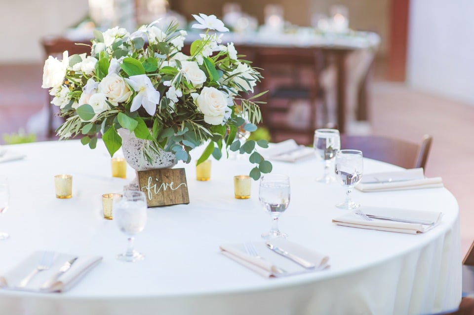 White and green centerpiece with wood table number