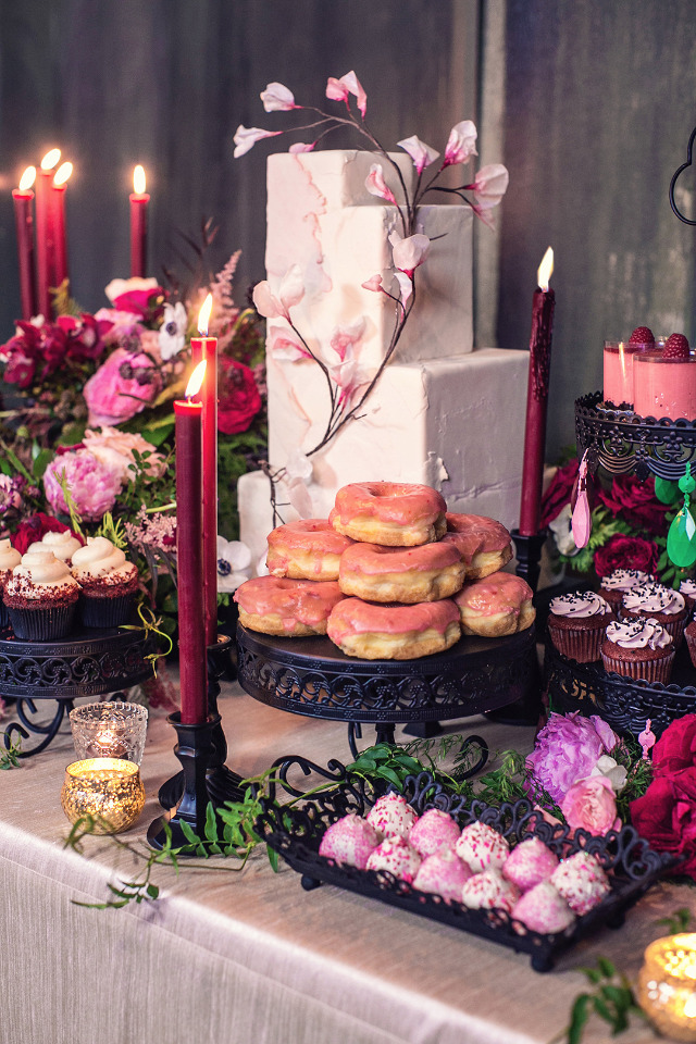 bright pink wedding desserts with red candles