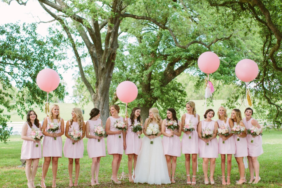 bridesmaids in knee length pink dresses