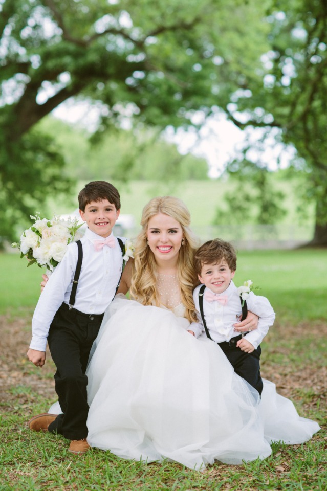 ring bearers in suspenders and pink bow ties