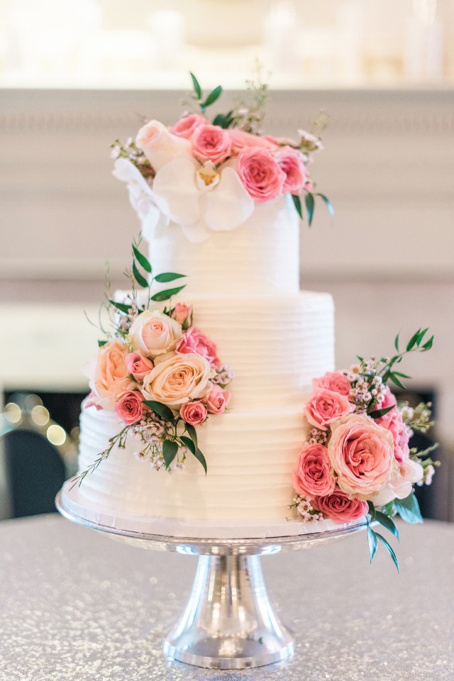 pink flower topped wedding cake