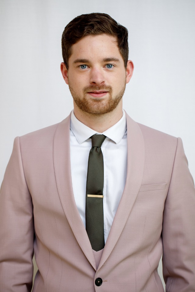 groom in dusty pink suit