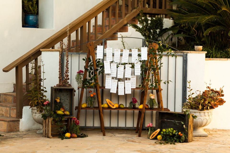 hanging wedding seating chart with fruit decor