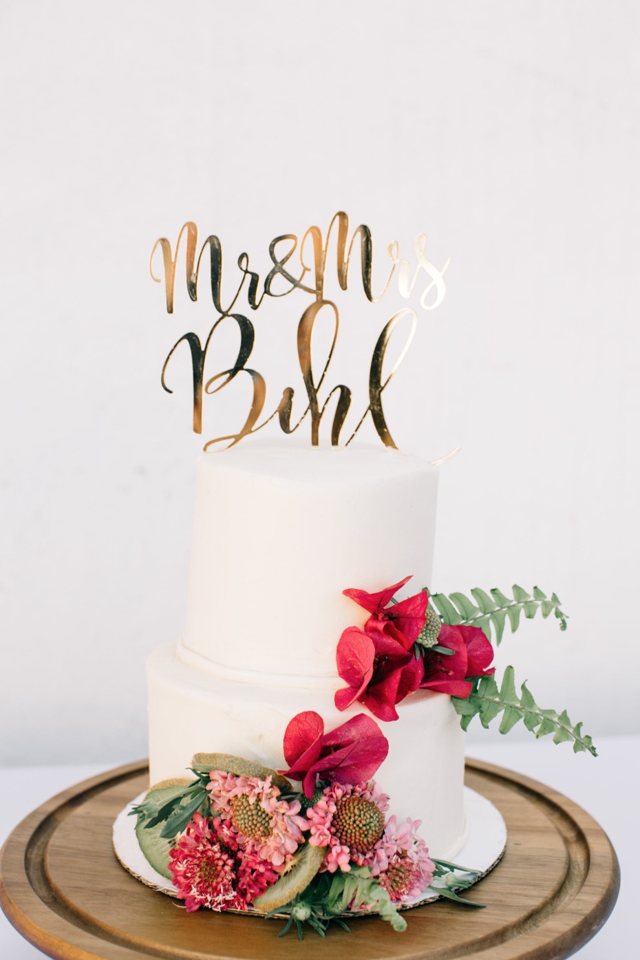 white wedding cake with gold cake toppber