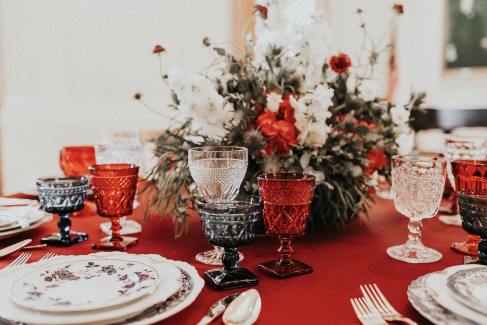 Elegant table setting with colorful glassware and florals