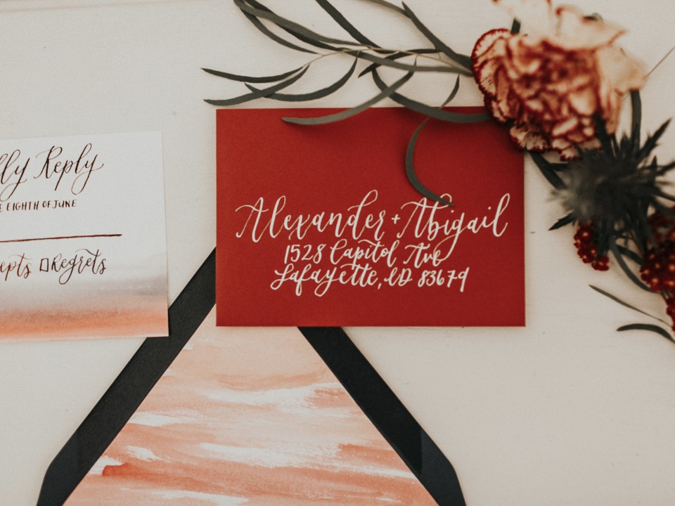 Elegant red wedding invitation with calligraphy details