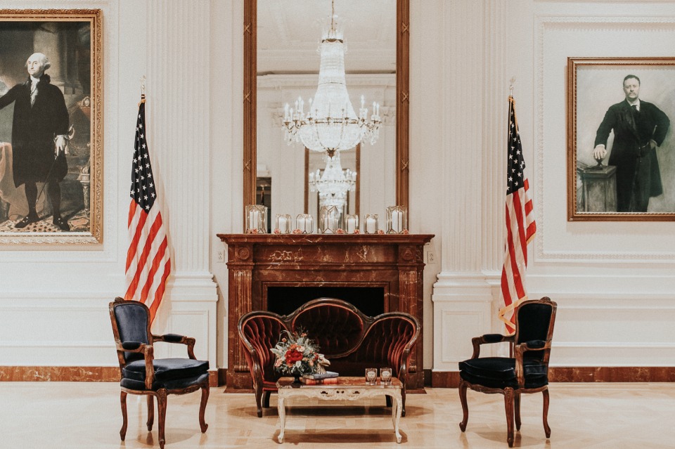 Elegant room with portraits flags and a chandelier
