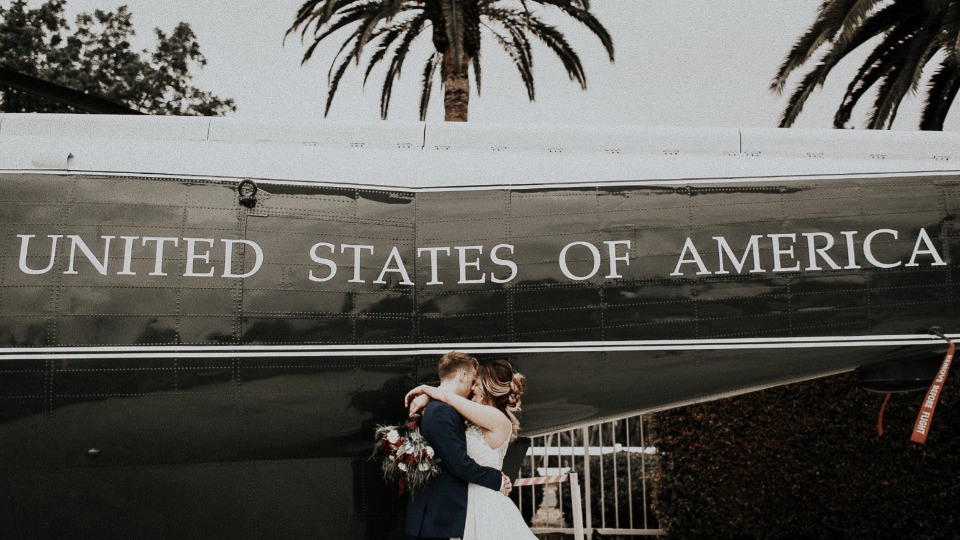Bride and groom with United States of America plane