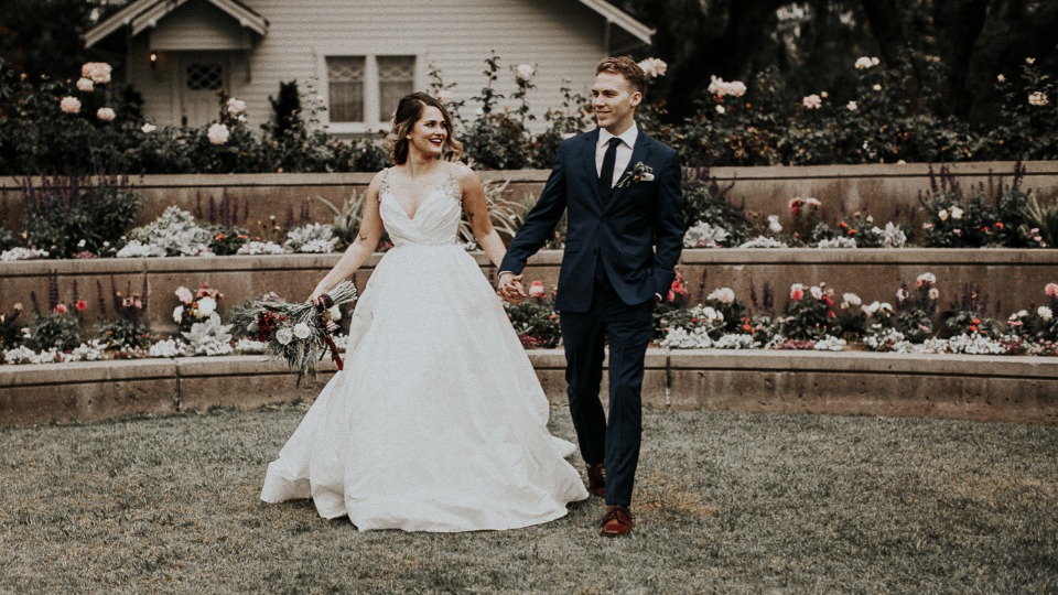 Bride and groom holding hands at outdoor wedding venue