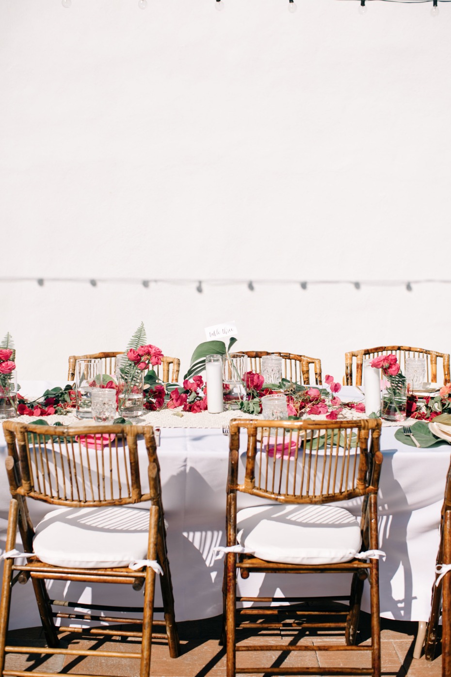 tropical boho wedding reception in magenta and white