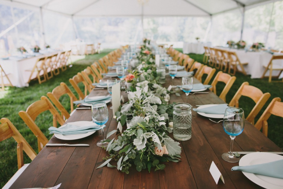 Green garland centerpiece on a wood table