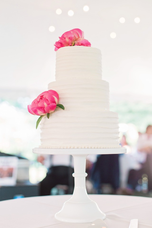 wedding cake topped with simple pink flowers