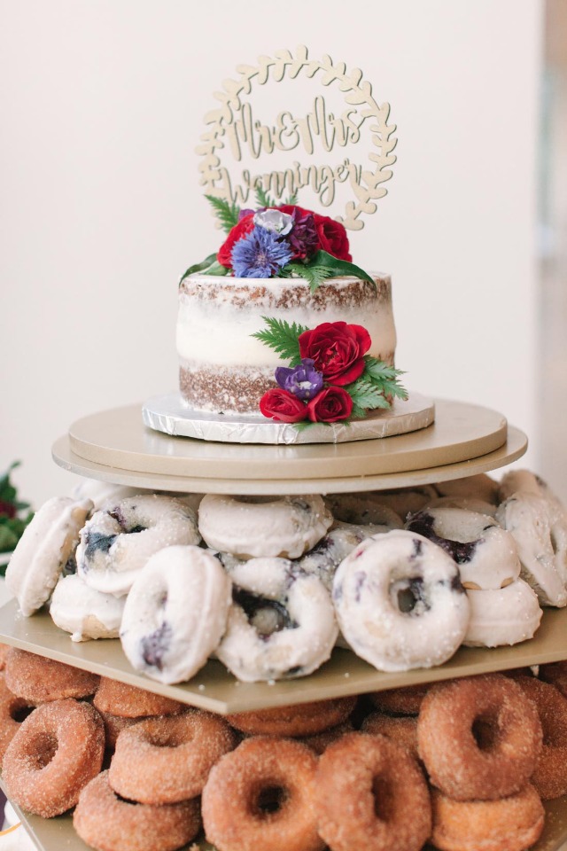 mini wedding cake on a tower of donuts