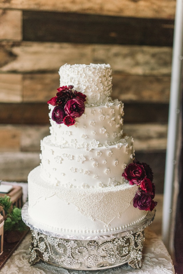 white cake topped with burgundy flowers