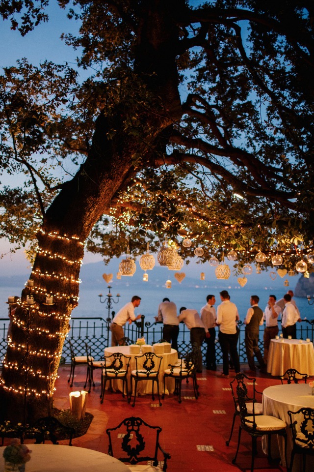 romantic twinkle lights and lanterns hung in the trees
