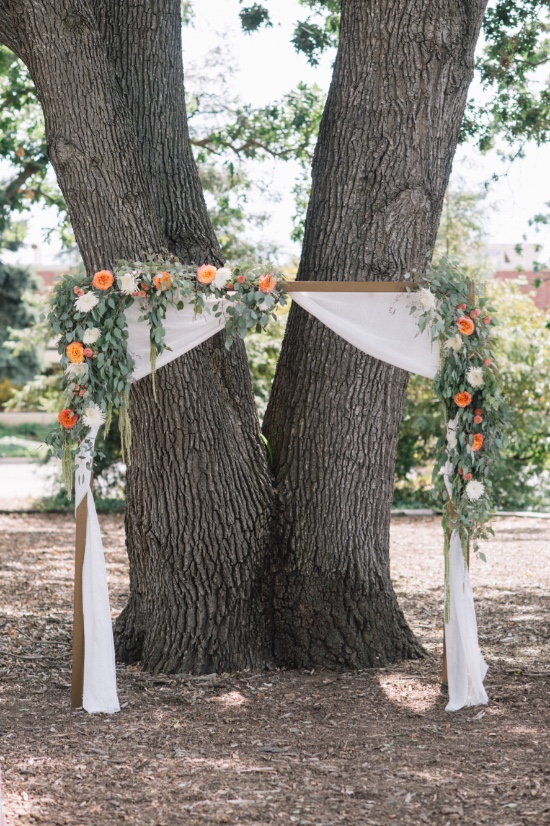 flower draped wedding arch