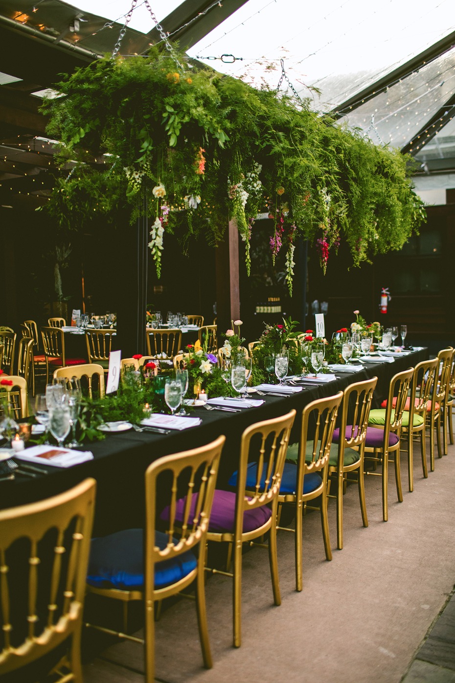 Greenery chandelier and Pantone colored gold chairs