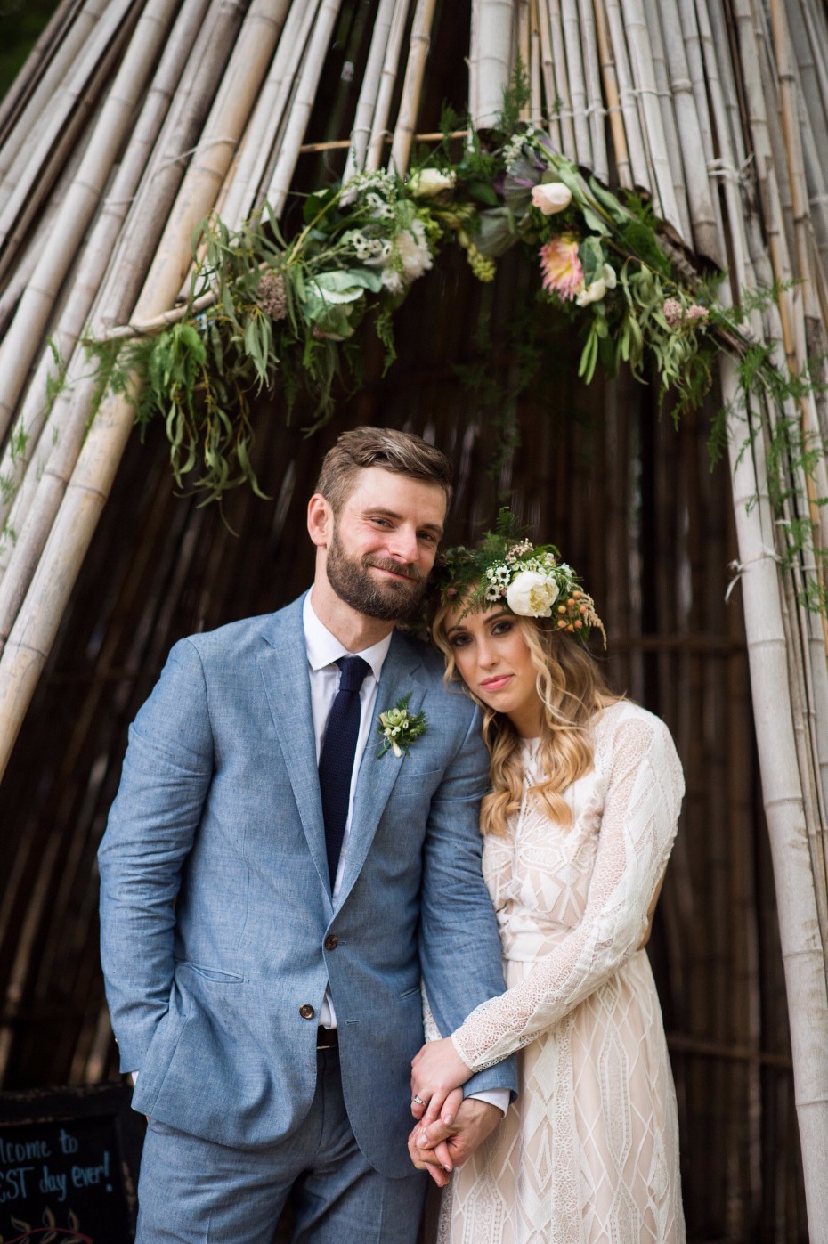 Boho Chic wedding couple bamboo arch with flowers