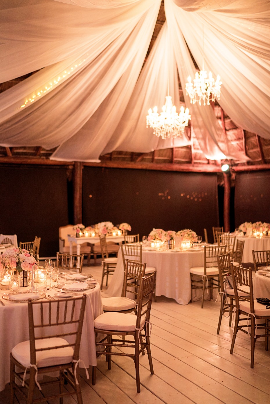 Dreamy candle lit reception with chandeliers