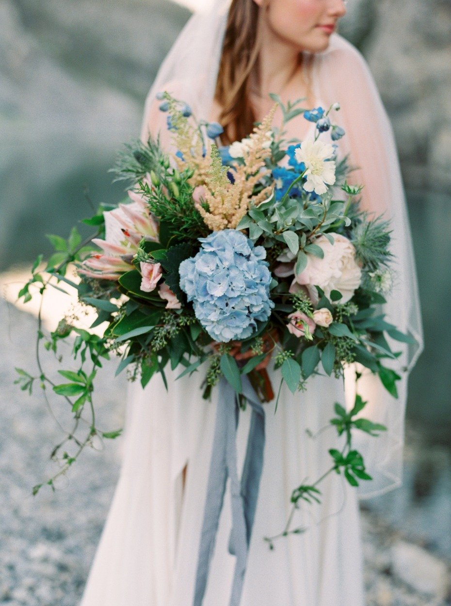 bride with her blue and pink wedding bouquet