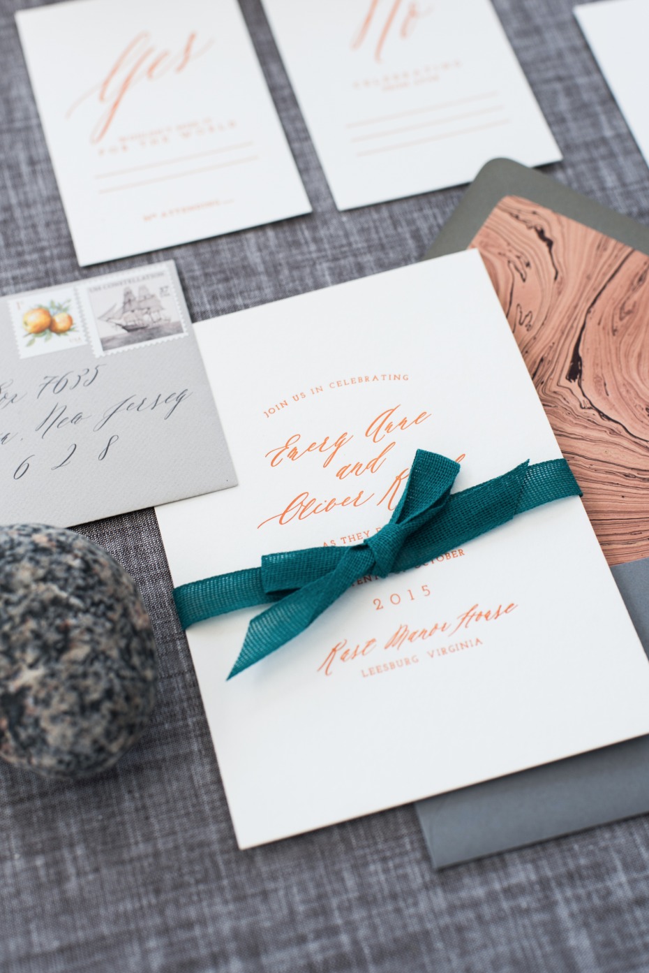 rose gold calligraphy wedding invites with emerald green ribbon