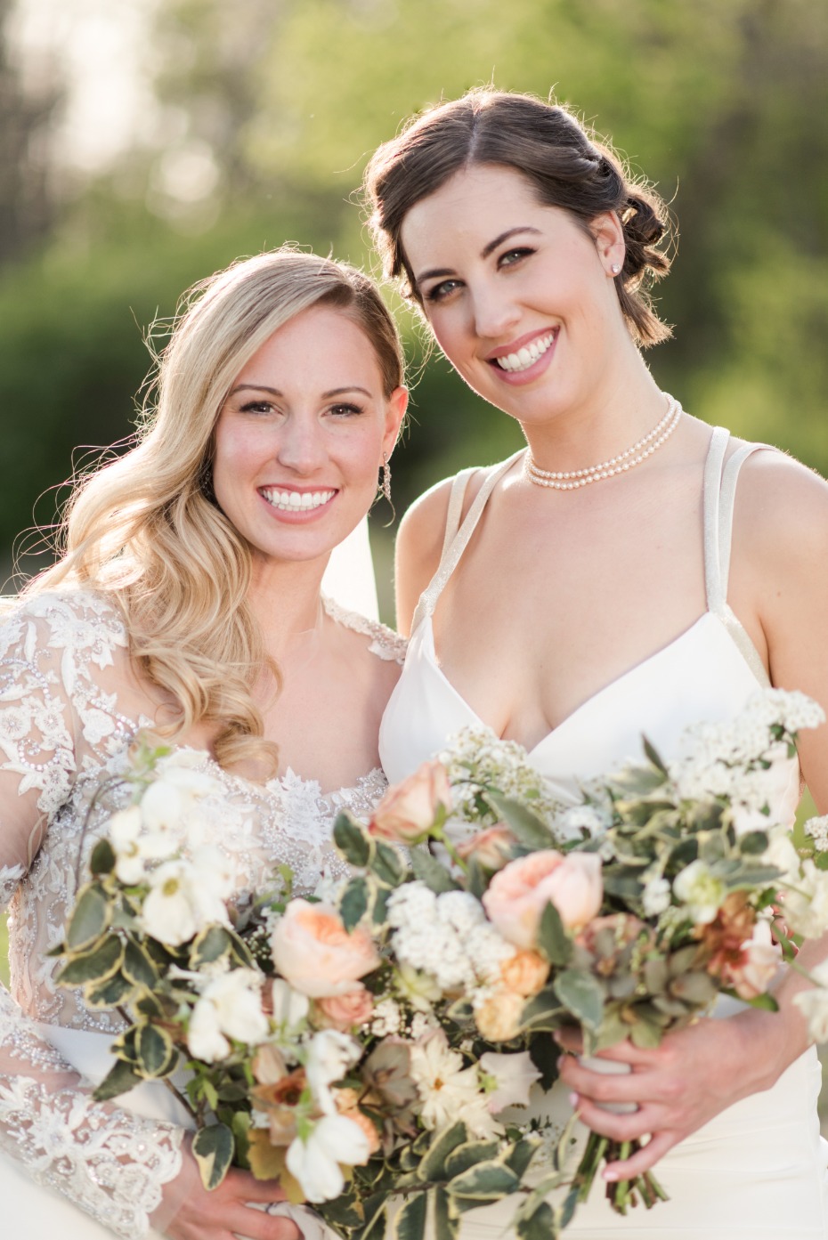 bride and her bridesmaid with peach and white bouquets