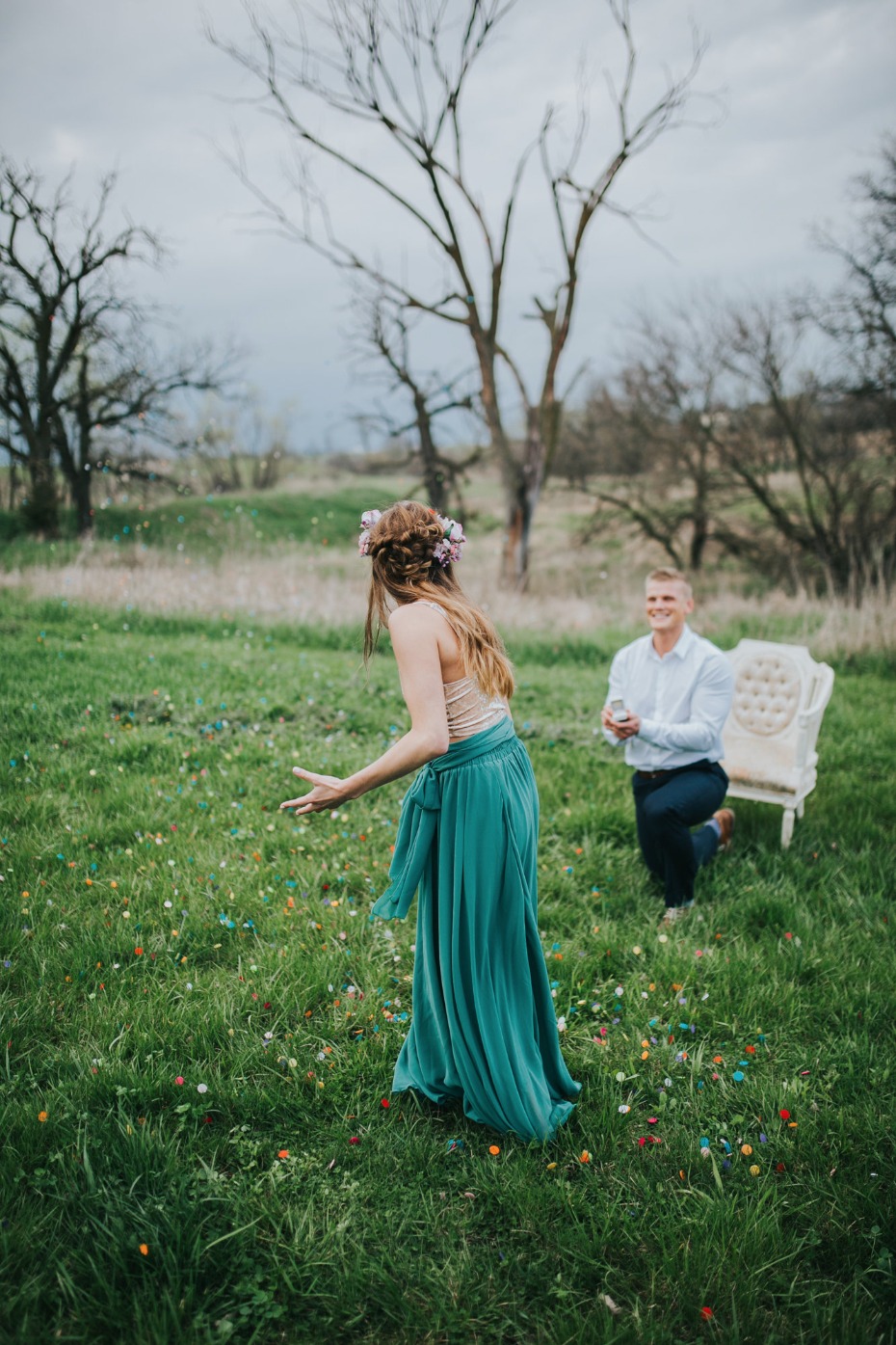 Romantic outdoor proposal with confetti on green grass