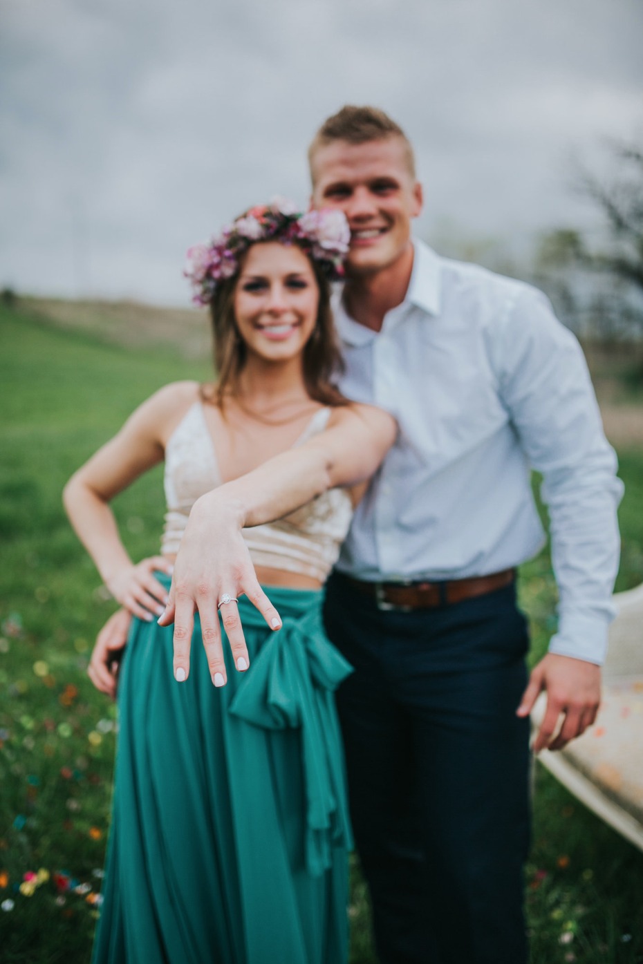 Happy couple celebrate their engagement with ring on display