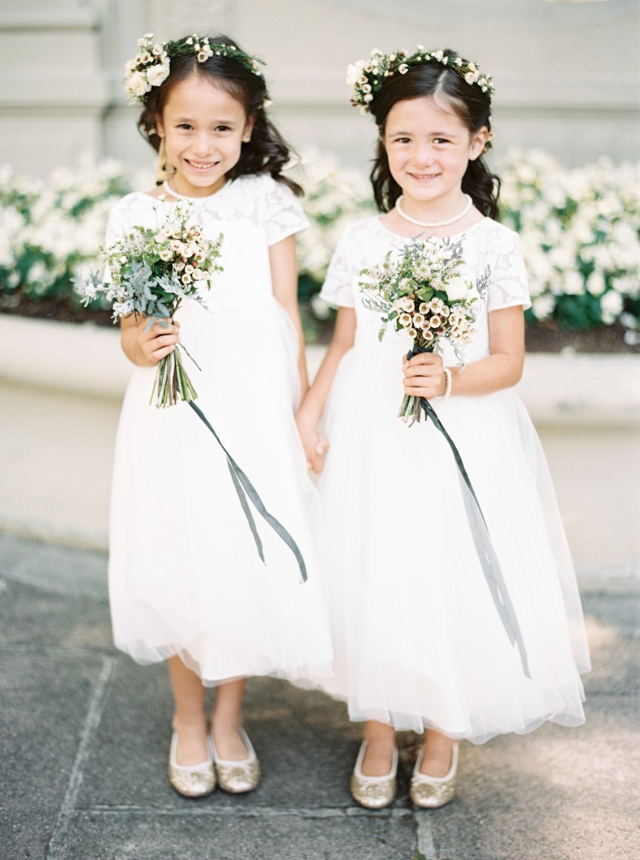 Flower girls with bouquets and ribbons