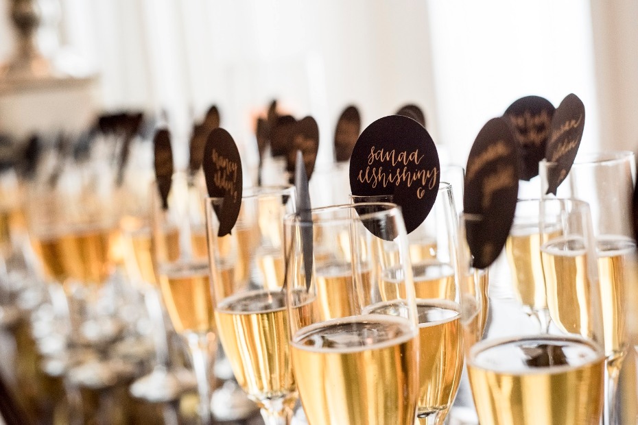 Champagne flutes with custom name tags at reception