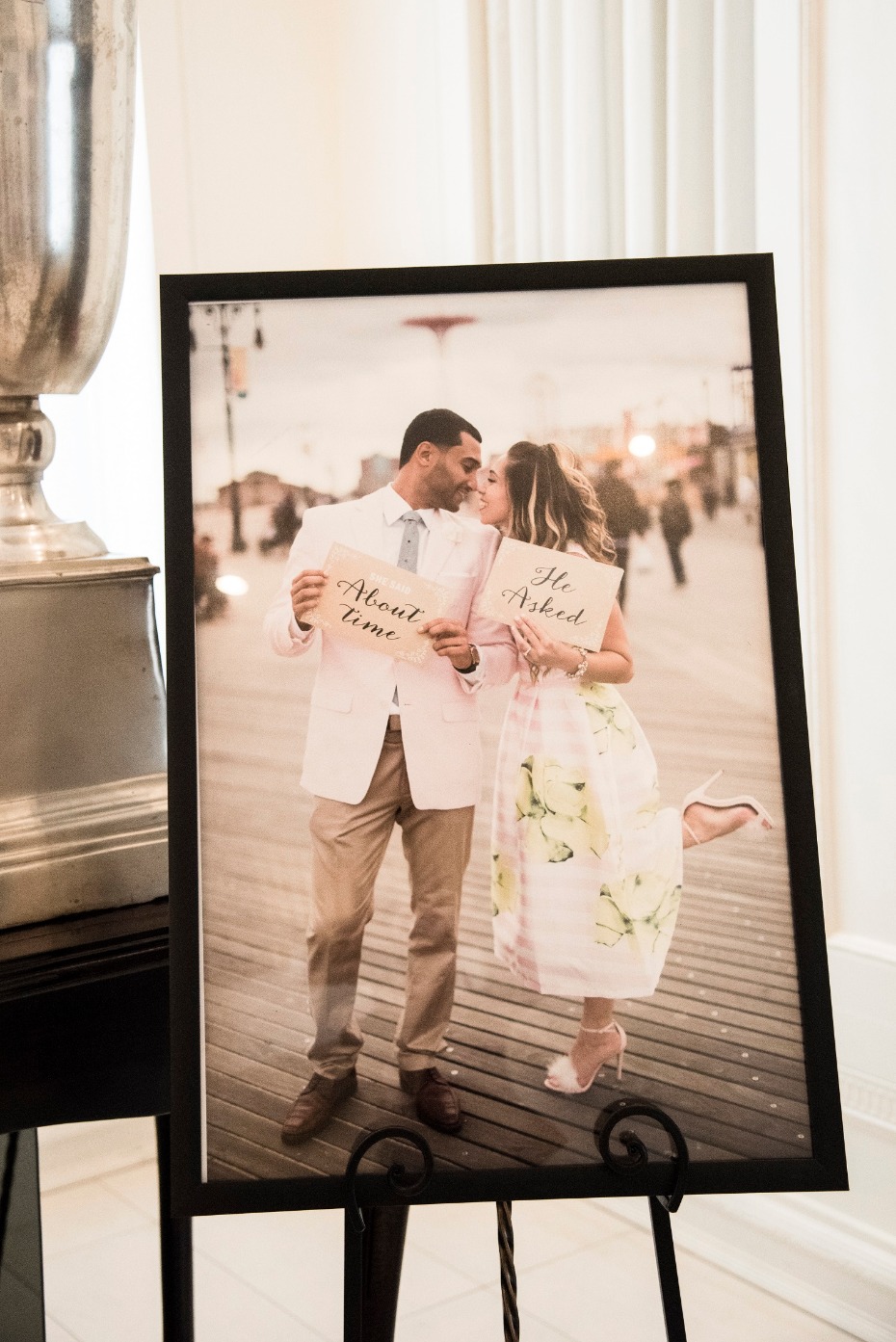 Framed engagement photo with signs about time he asked