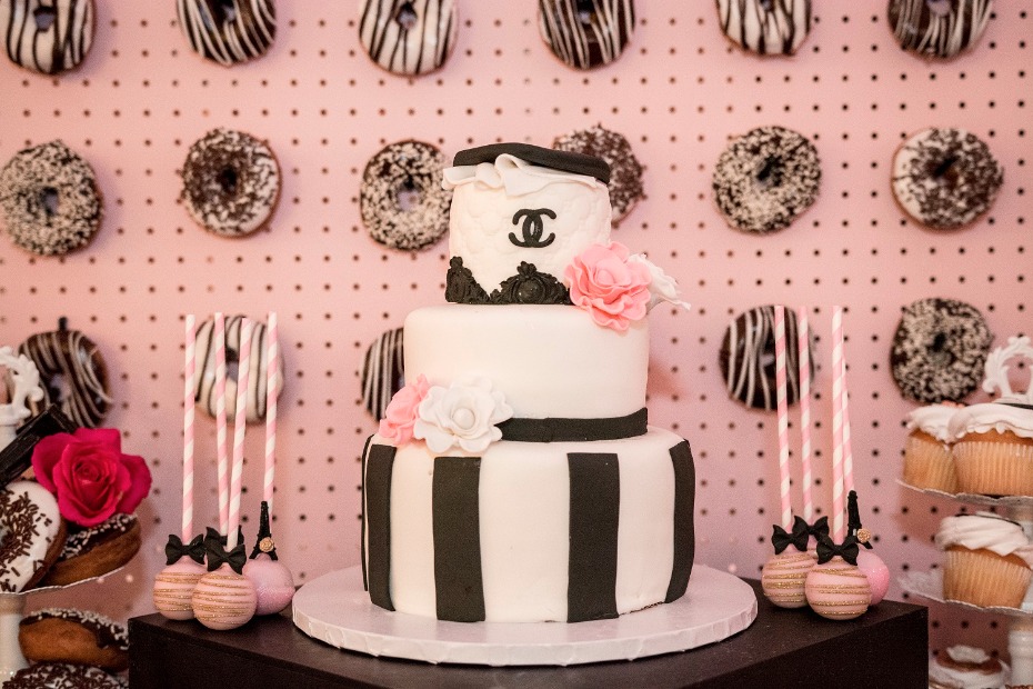 Elegant Chanel themed cake with donuts and cupcakes