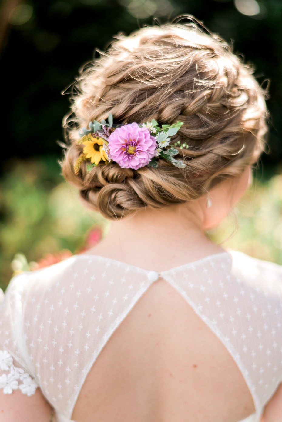 braided wedding hair updo accented by flowers