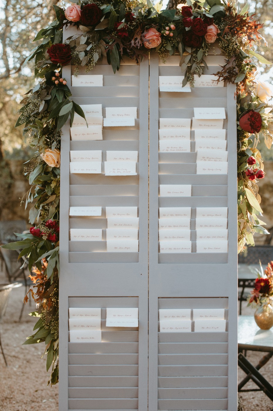 Shutter seating chart with fall floral garland