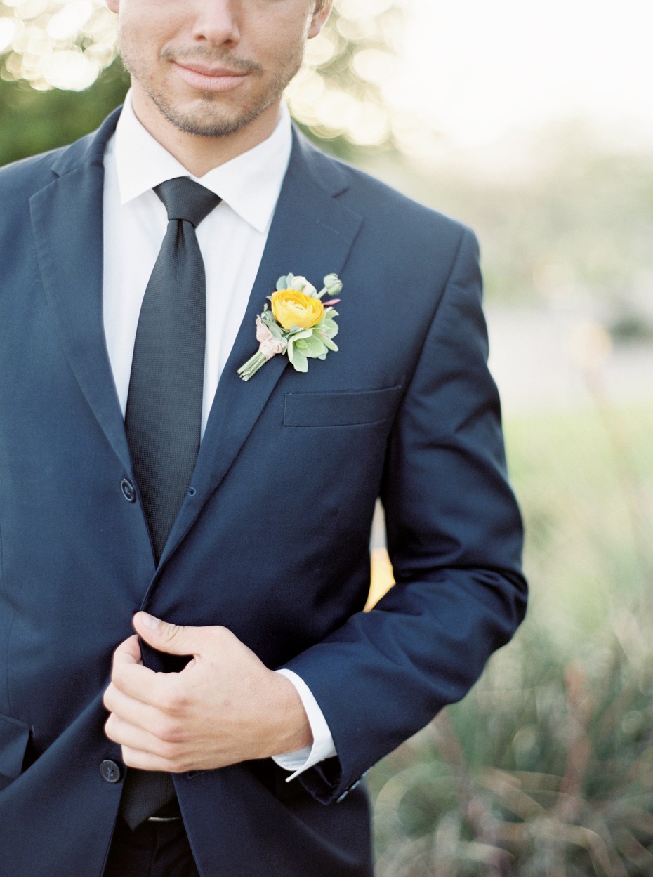 Navy suit and yellow boutonniere