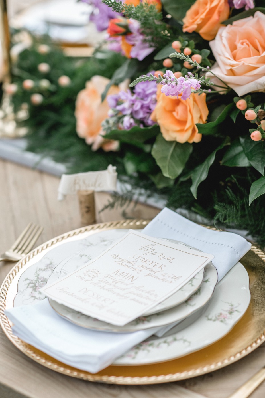 fantasy wedding place setting with gold and floral print china