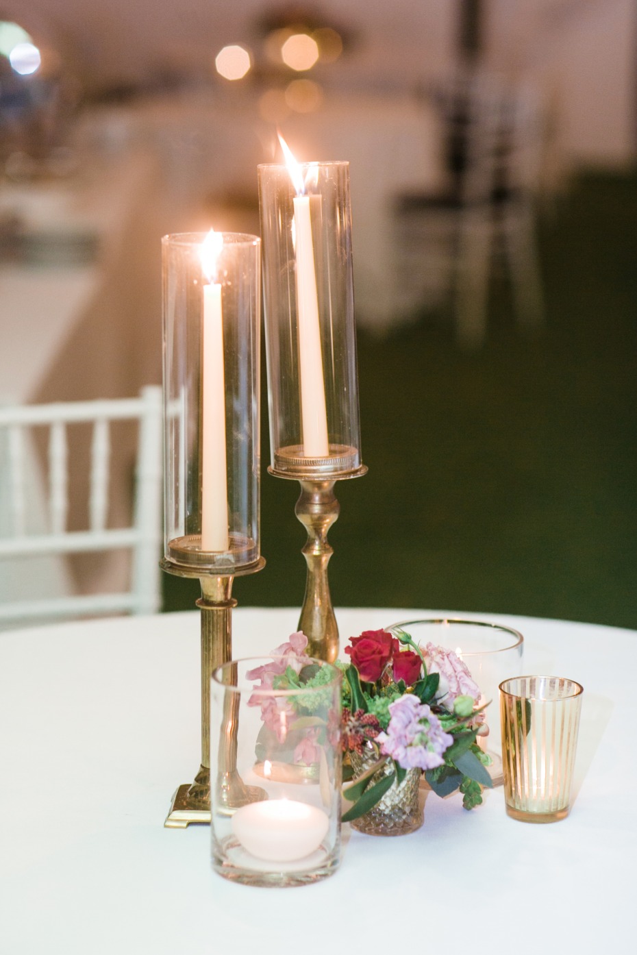 Simple yet elegant centerpiece with candles and florals
