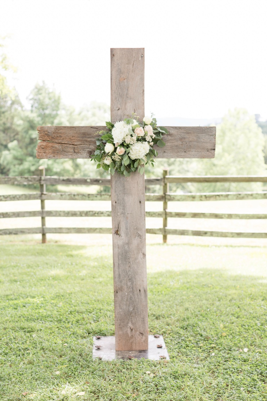 wooden cross decorated with flowers for wedding ceremony