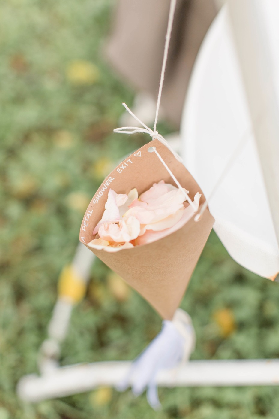 guests throw rose petals down the aisle