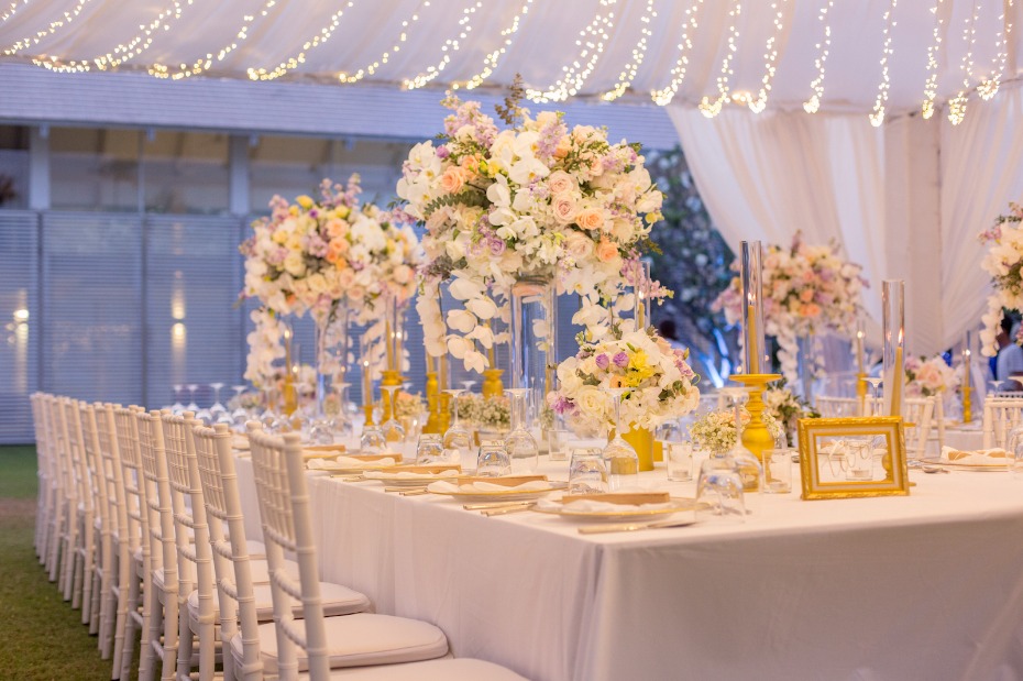 Elegant wedding reception table with flowers and lights